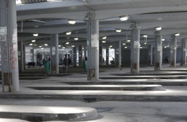 File: Commuters wait for transport at a deserted taxi rank. AFP/Gianluigi Guercia