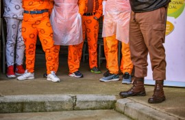 File: Prisoners standing next to a Correctional Services guard. Sharon Seretlo/Gallo Images via Getty Images