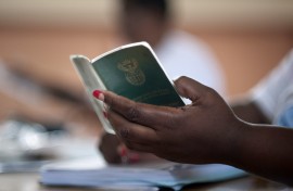 File: A woman holds an Identity book. 