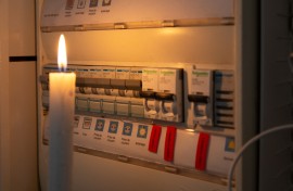 File: A candle next to an electricity meter. AFP/Valerie Dubois/Hans Lucas