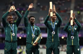 Silver medallists South Africa's Bayanda Walaza, Shaun Maswanganyi, Bradley Nkoana and Akani Simbine celebrate on the podium after competing in the men's 4x100m relay final of the athletics event during the Paris 2024 Olympic Games at Stade de France in Saint-Denis, north of Paris, on August 9, 2024.