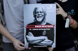  File: Protesters hold a placard as they attend a demonstration in support for NGO Sea Shepherd Conservation Society Canadian founder Paul Watson. AFP/Stephane De Sakutin