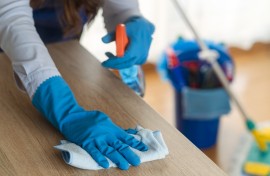 File: A domestic worker cleaning a desk. GettyImages/Dusan Sapic