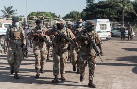 File: SANDF members walk as they take part in a law enforcement operation. AFP/Rajesh Jantilal