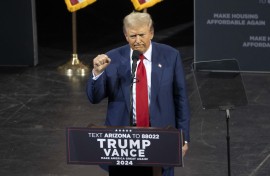 Former US President and Republican presidential candidate Donald Trump clenches his fist as he leaves after speaking during a campaign event. AFP/Rebecca Noble