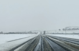 A general view of heavy snowfall on a road to Harrismith from Sterkfontein dam on September 21, 2024. 