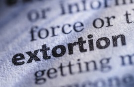The word extortion in a dictionary. GettyImages/JLGutierrez