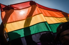 People with a rainbow flag take part in a Gay Pride Parade AFP/Rajesh Jantilal