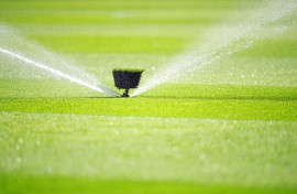 File: A water sprinkler spraying water. Michael Kappeler/dpa Picture-Alliance via AFP