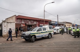 SAPS cars are seen during an inspections on spaza shops in Naledi, Soweto. AFP/Shiraaz Mohamed