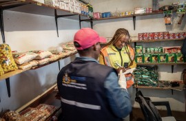 Members of the Department of Health as they conduct an inspection on a spaza shop in Naledi, Soweto. AFP/Shiraaz Mohamed