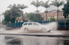 A vehicle drives through a flooded street following heavy rains. AFP/Rajesh Jantilal