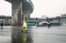 People walk pass the Warwick Market under heavy rain in the city of Durban. AFP/Rajesh Jantilal