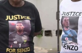 Family members with shirts calling for justice for Senzo Meyiwa.