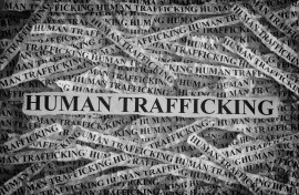 File: Torn pieces of paper with the words Human Trafficking. GettyImages/Professor25