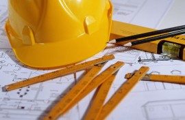 File: Hard hat and architectural blueprints.