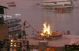 File: A cremator of the Dom community burns a funeral pyre at Harishchandra Ghat along the banks of river Ganges in Varanasi. AFP/Niharika Kulkarni