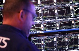 Traders work on the floor of the NYSE during the morning trading. Michael M. Santiago/Getty Images/AFP
