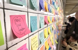 People leave post-it notes as they take part of the Subway Therapy project. AFP/Diane Desobeau