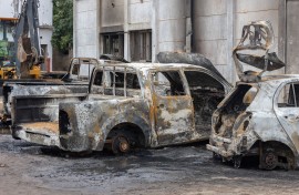 File: A general view of the rubble of three cars that were burned inside the offices of the Mozambique Liberation Front party (FRELIMO) in the Maxaquene neighbourhood of Maputo on November 8, 2024, following clashes between protesters and riot police the previous day. 