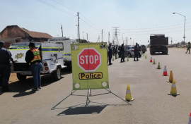 Police officers monitoring a roadblock. Twitter/@SAPoliceService