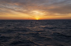 File: The sun rises over the Atlantic Ocean.