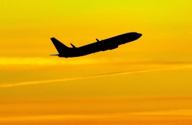Aircraft silhouette, a symbol illustration photo during the magic hour of a departing passenger plane. 