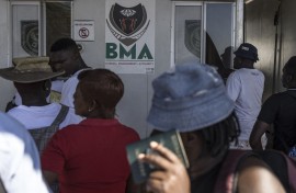 Zimbabwean migrants wishing to enter South Africa queue at a passport check before the immigration offices at the Beitbridge crossing. AFP/Marco Longari