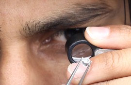File: A supervisor checks the shape and color of a polished diamond. Rupak de Chowdhuri/NurPhoto via AFP