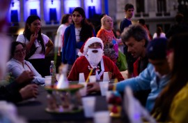 A man dressed as Santa Claus looks on as he takes part in a Christmas solidarity dinner called 'No Families Without Christmas'. AFP/Tomas Cuesta
