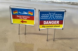 Warnings for swimming conditions on a beach. eNCA/Ronald Masinda