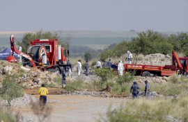 Rescuers and SAPS members seen during a rescue operation to retrieve illegal miners from an abandoned gold shaft in Stilfontein. AFP/Christian Velcich