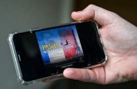A man looks at an advert of the Pakistan International Airlines (PIA) plane flying at the Eiffel Tower. AFP/Farooq Naeem