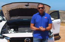 image of Justin Ford standing against white Mazda on Drive episode 07