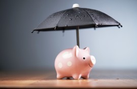 File: A piggy bank with an umbrella. GettyImages/seng kui Lim/500px