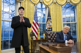 Elon Musk speaks as US President Donald Trump looks on in the Oval Office. AFP/Jim Watson.jpg