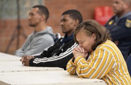 Kelly Smith and co-accused Steveno van Rhyn (C), and Jacquen Appollis. AFP/Rodger Bosch