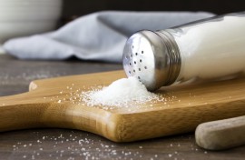 Salt spilling out of a salt shaker. GettyImages/Synergee
