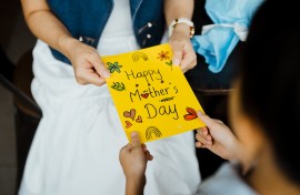Close-up of woman receiving a Mother's Day card.GettyImages/Chong Kee Siong