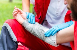 File: A paramedic treating burns on a victim's arm. GettyImages/microgen