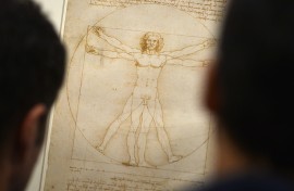 People look at the "Vitruvian Man" a drawing by Leonardo da Vinci. AFP/Gabriel Bouys
