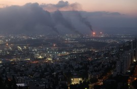 Smoke billows from a site in the city of Haifa following a fresh barrage of Iranian missiles. AFP/Ahmad Gharabli