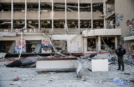 An Israeli police officer inspects the site where an Iranian ballistic missile reportedly struck in Haifa, Israel. Matan Golan/Middle East Images via AFP