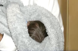 Baby Mogamat fast asleep in his mother's arms.