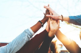 a high five with a diverse a group of people 