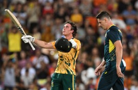 South Africa's batsman Dewald Brevis (L) celebrates scoring his century as Australia's bowler Ben Dwarshuis (R) looks on during the second Twenty20 international cricket match between Australia and South Africa in Darwin on August 12, 2025.