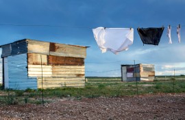 File: A school uniform hangs among shacks. GettyImages/Per-Anders Pettersson