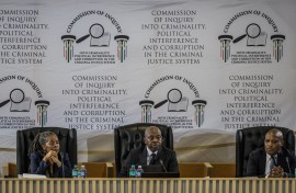 Justice Mbuyiseni Madlanga delivers his remarks during the judicial commission of inquiry probing Provincial Police Commissioner Nhlanhla Mkhwanazi's claims. AFP/Phill Magakoe