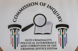 A general view of a logo of the Commission of Inquiry into criminality, political interference and corruption in the criminal justice system. AFP/Phill Magakoe