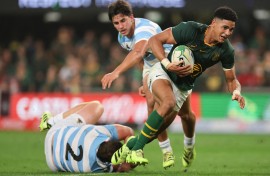South Africa's fly-half Sacha Feinberg-Mngomezulu (R) runs with the ball to score a try during the Rugby Championship Test match between South Africa and Argentina at Kings Park Stadium in Durban on September 27, 2025.